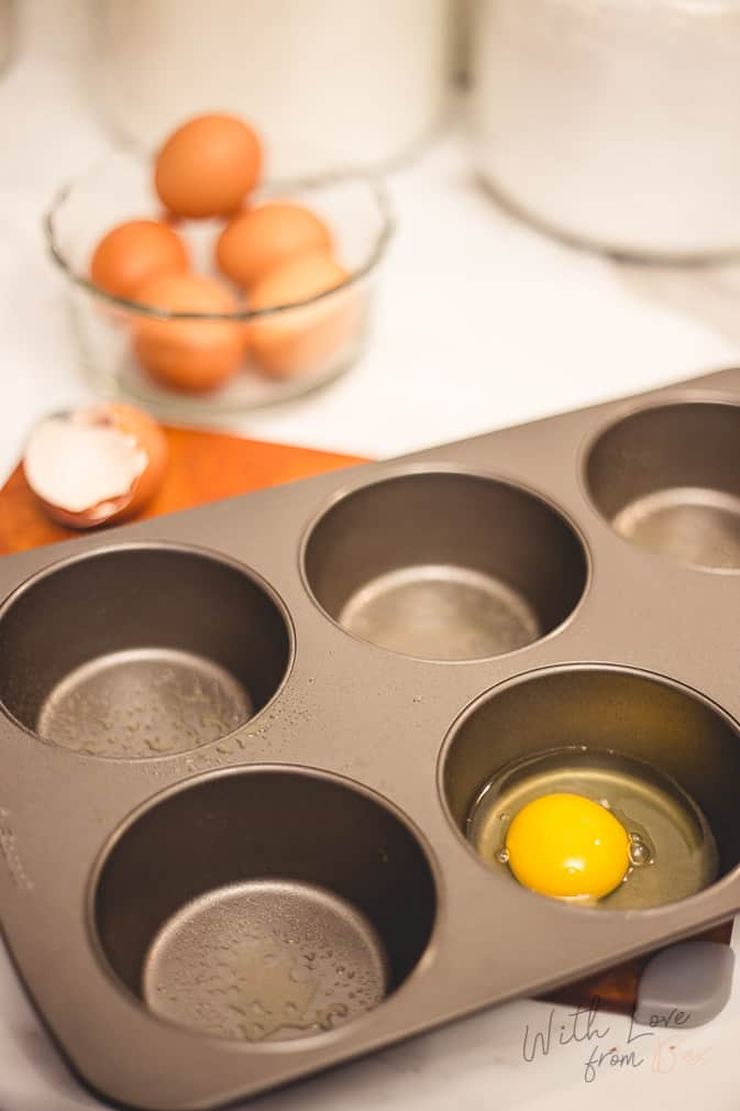 uncooked egg in a greased muffin tray