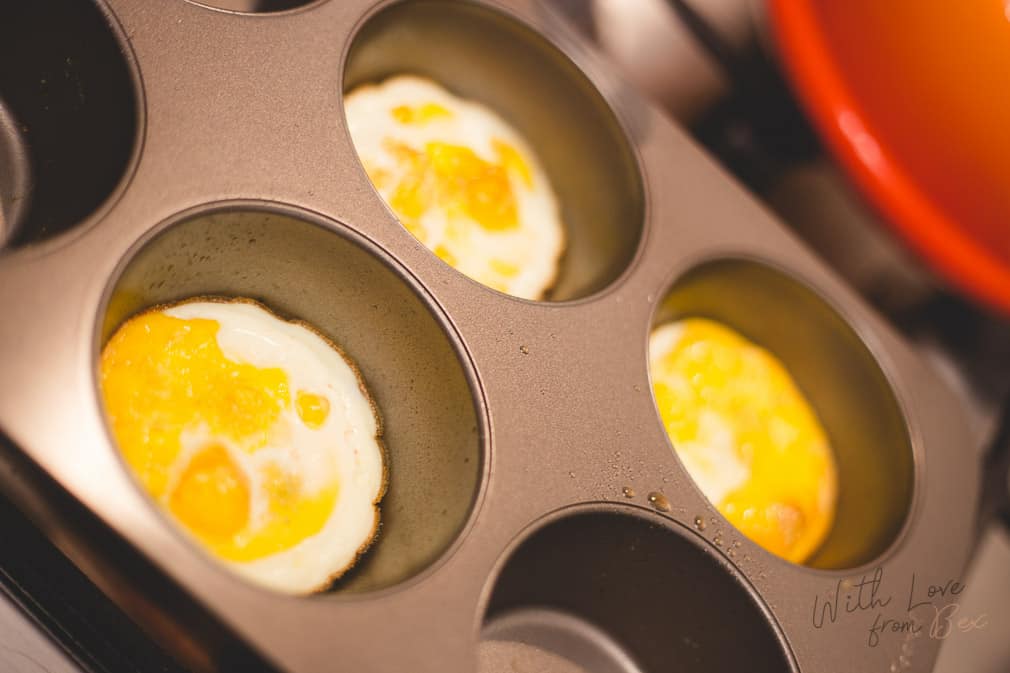 6 cooked eggs in a greased muffin tray