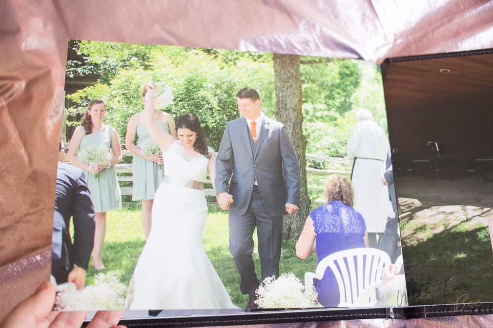 bride cheering with groom as they walk down the aisle of their outdoor wedding