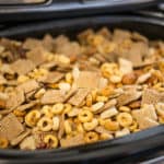 mixture of chex cereal, nut, and pumpkin spice in a slow cooker
