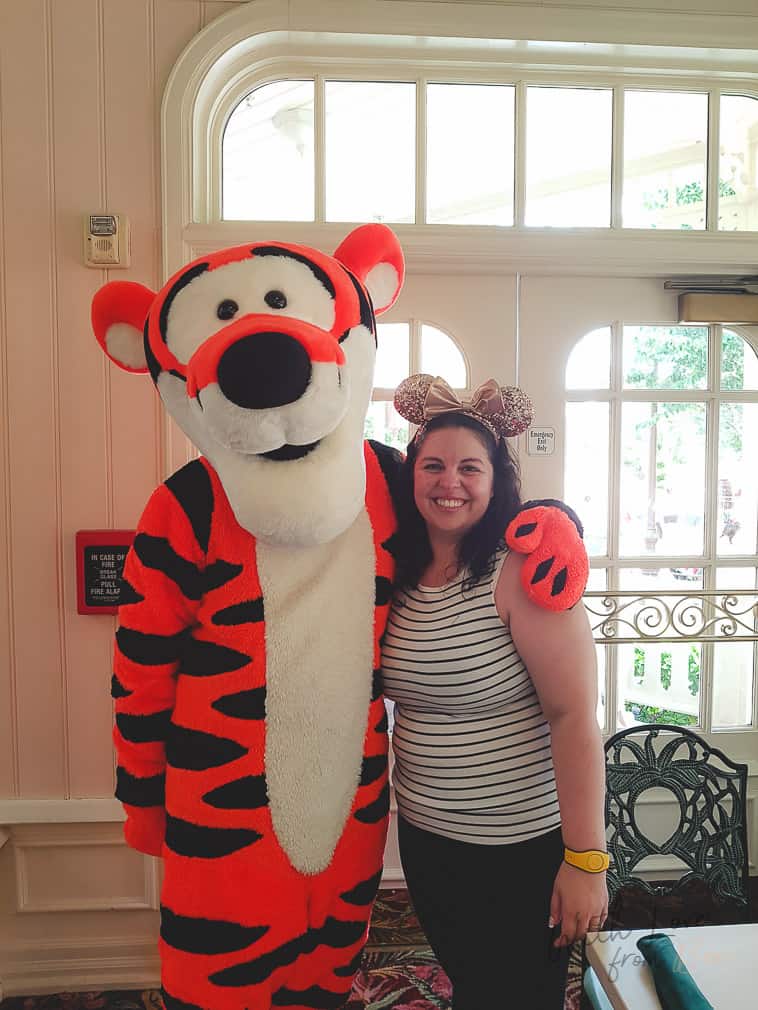 woman standing with Tigger at Crystal Palace at Magic Kingdom