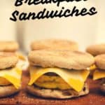 ready made breakfast sandwiches on a cutting board. image reads freezer friendly breakfast sandwiches