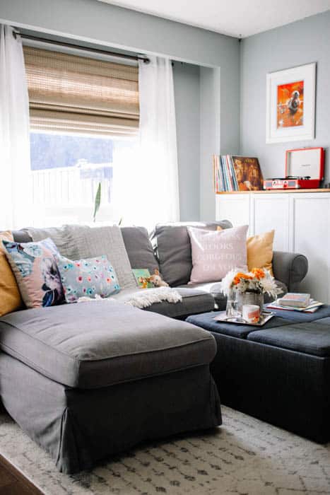 Bright living room with spring coloured pillows and flowers, of pinks and yellows