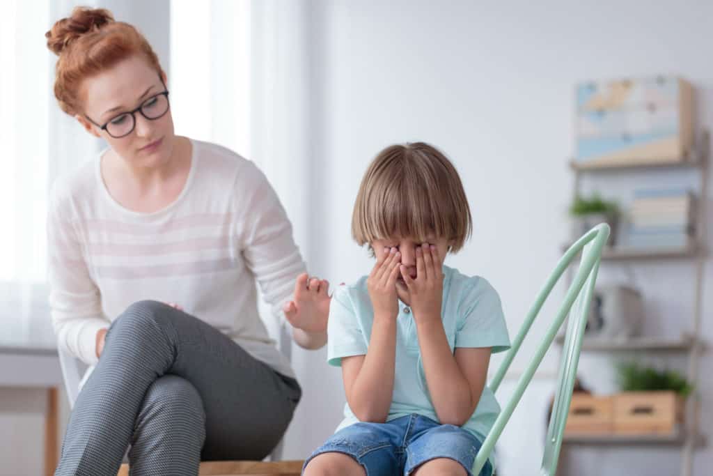 Worried mother comforting crying son